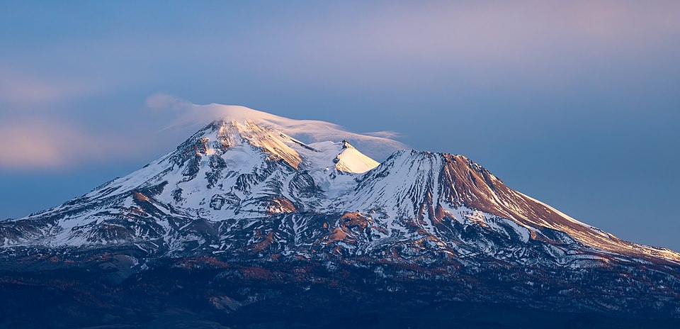 The north face of the volcano Mount Shasta (Karuk: “Úytaahkoo”) as seen from Siskiyou County Route A12 at sunset